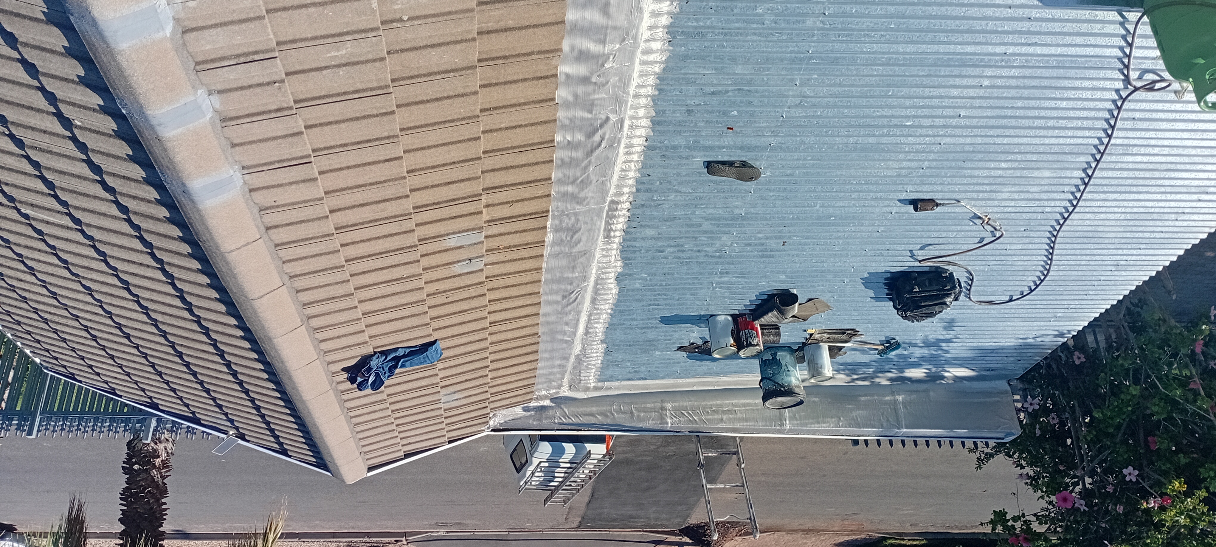 Wide view of completed blue-grey roof protection and sealing