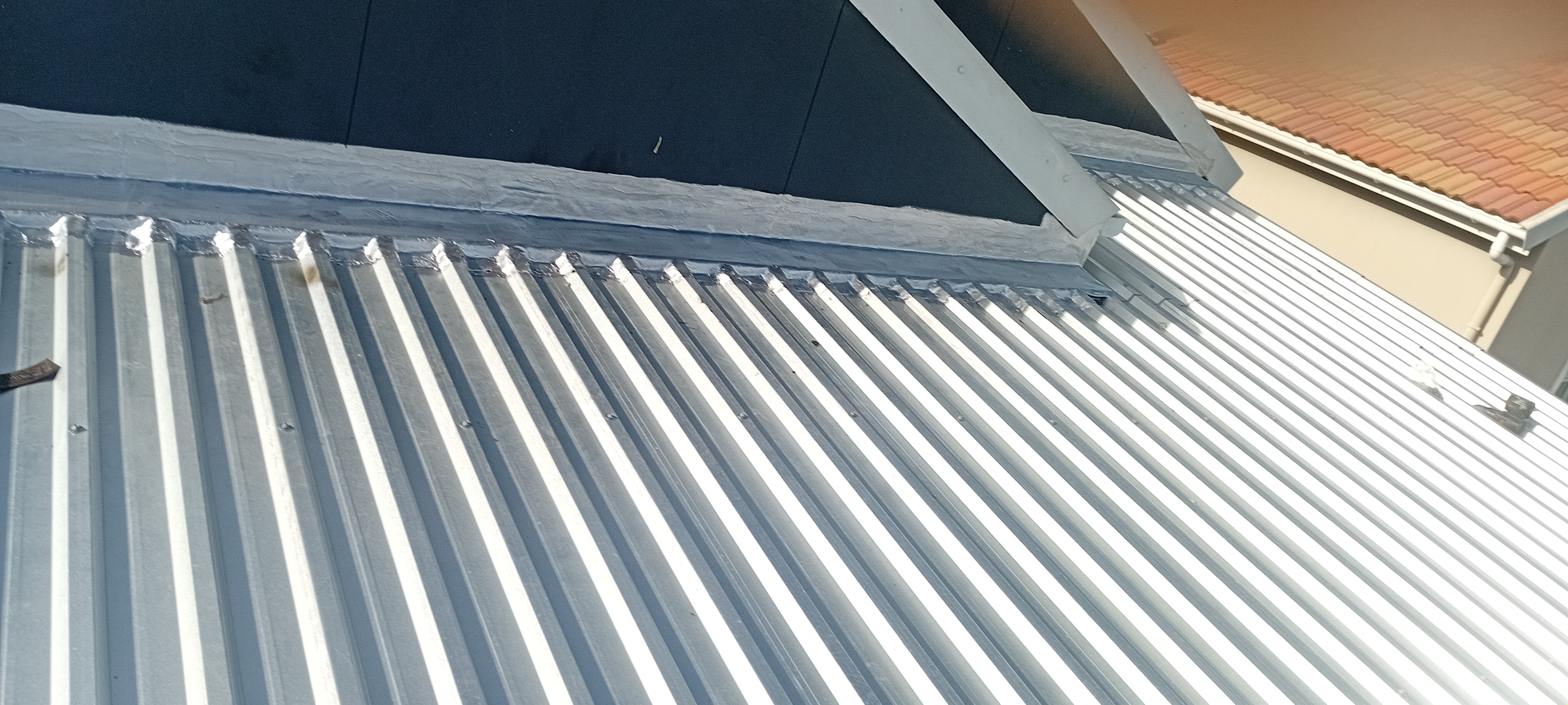 Protected roof panel junction after sealing work