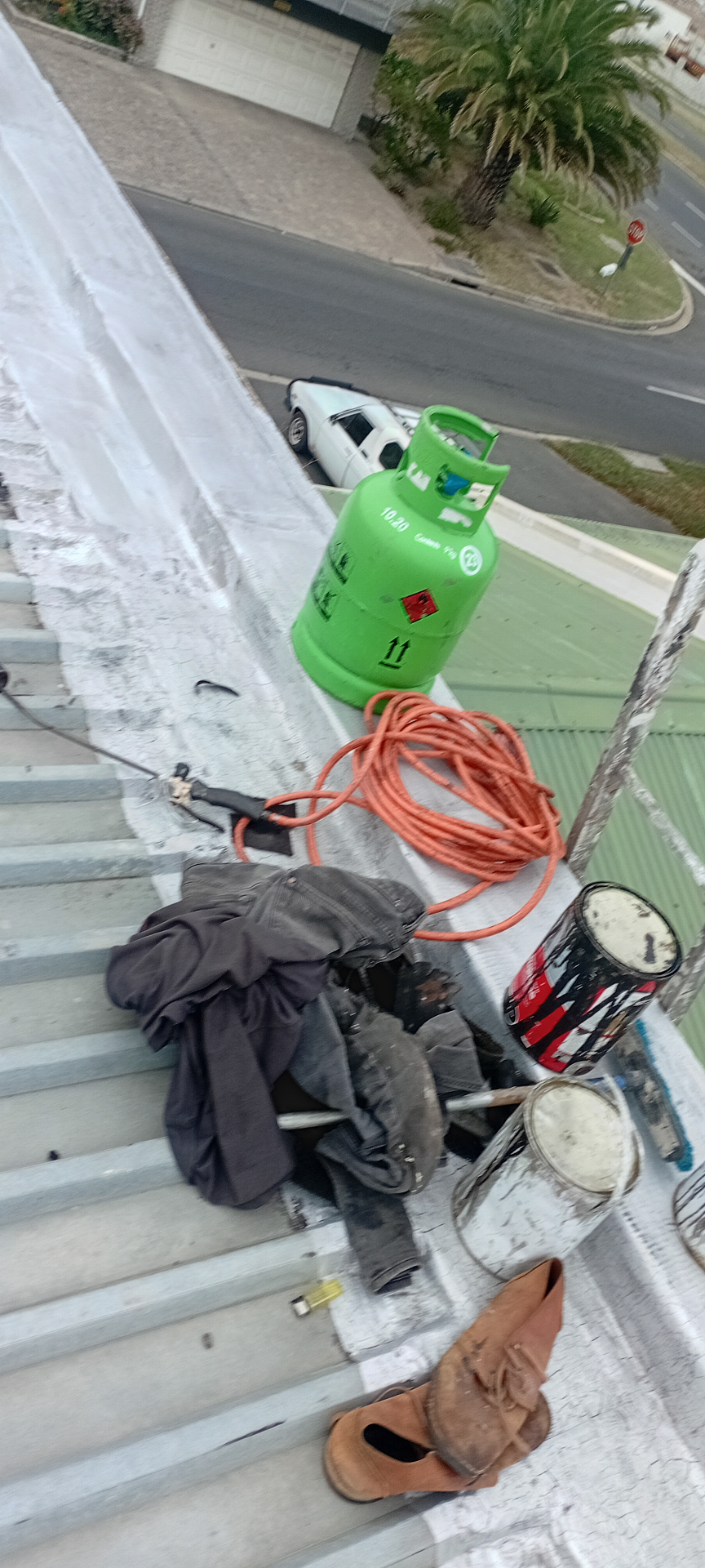 Roof edge work area prepared for coating and sealing