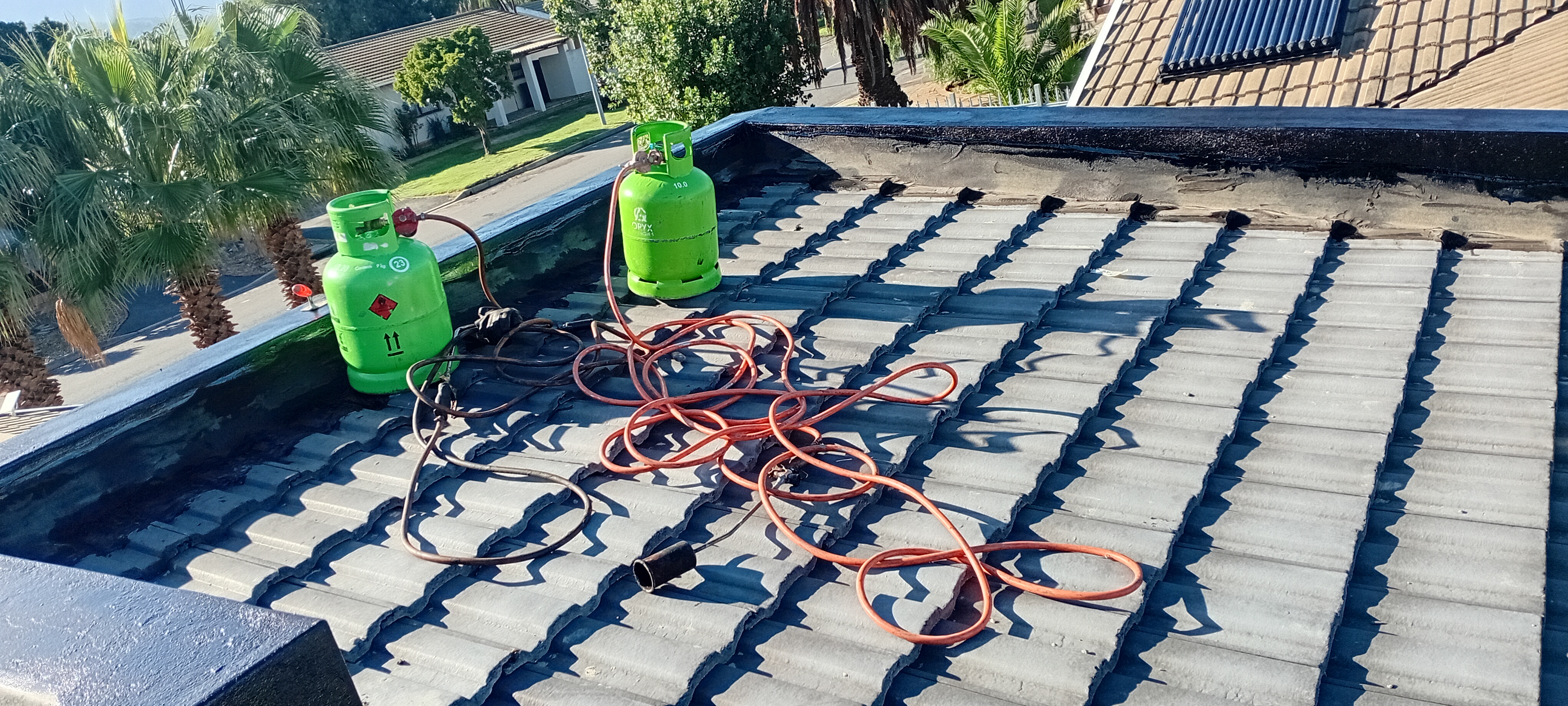 Roof repair setup with tools during waterproofing preparation