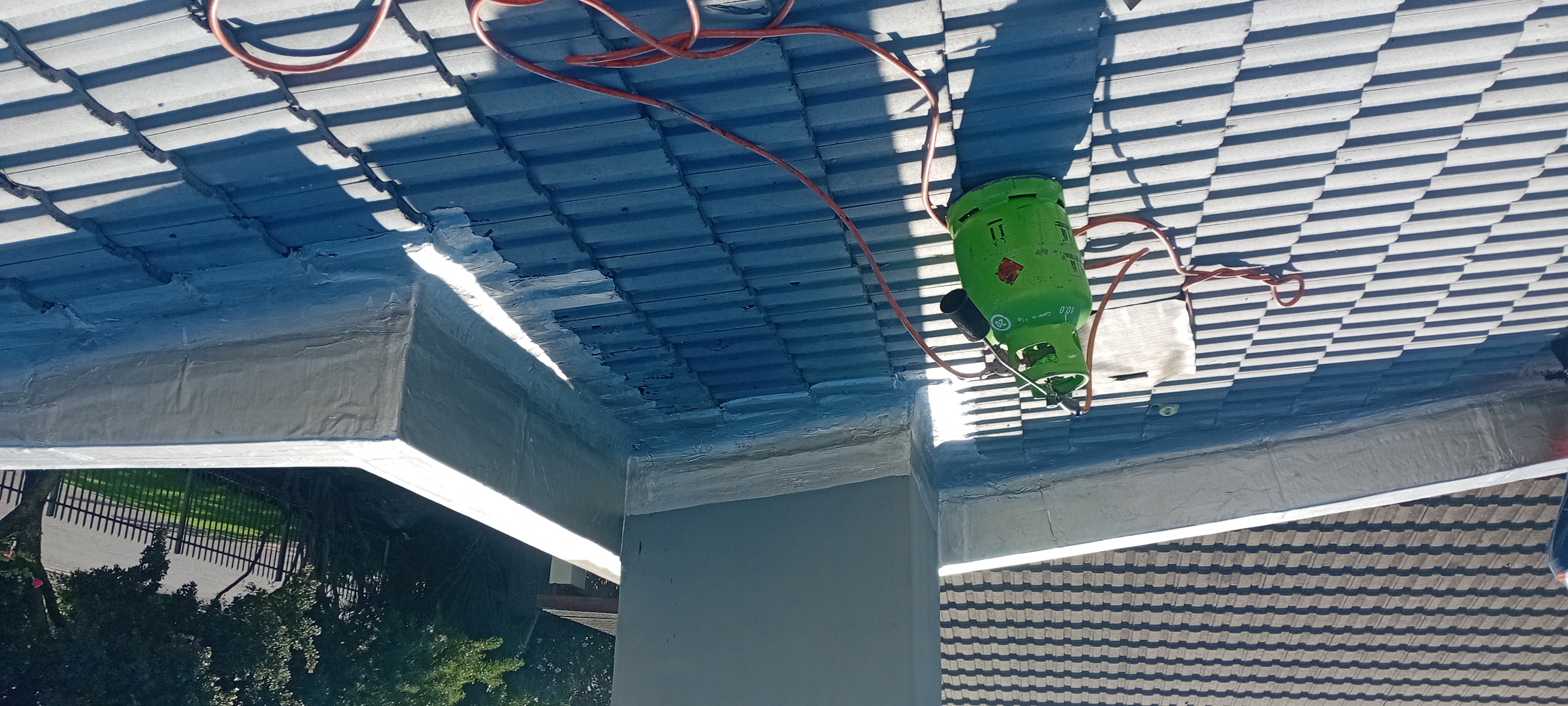 Finished roof repair around a parapet and valley